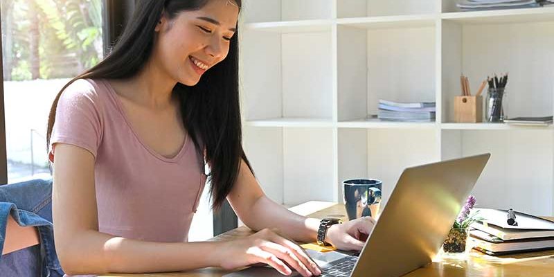 Student formatting scholarship essay on her laptop