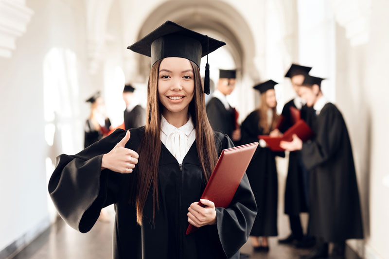 New graduate student in cap and gown