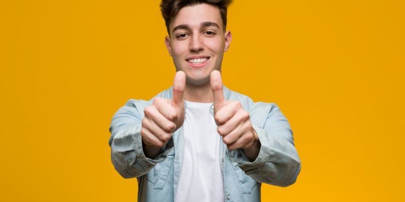 College student giving thumbs up for scholarship