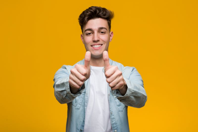 College student giving thumbs up for scholarship